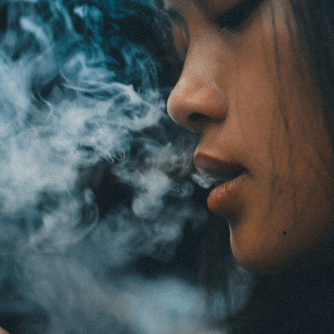woman with blue and white smoke